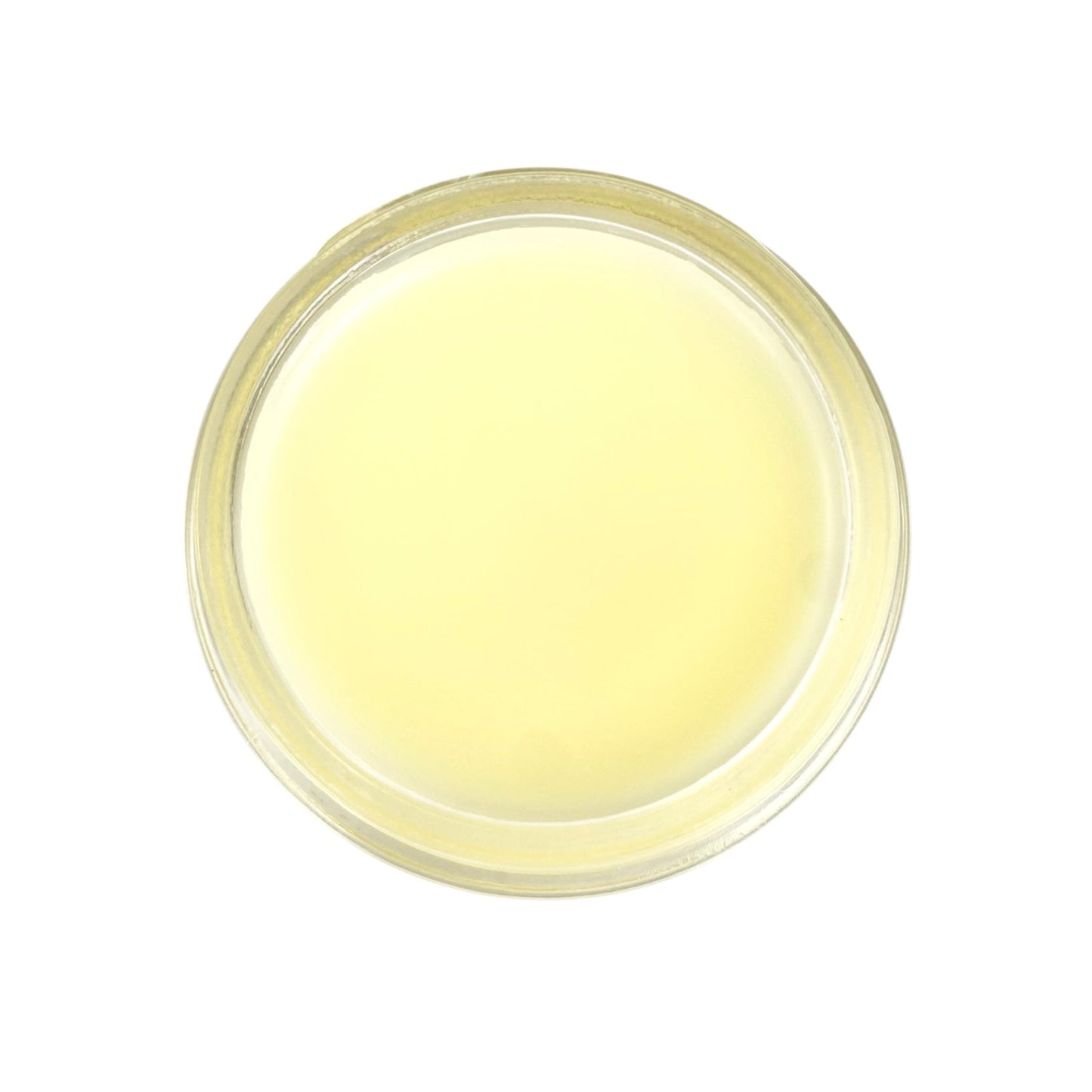 Round container of yellow nourishing and restorative balm on a white background