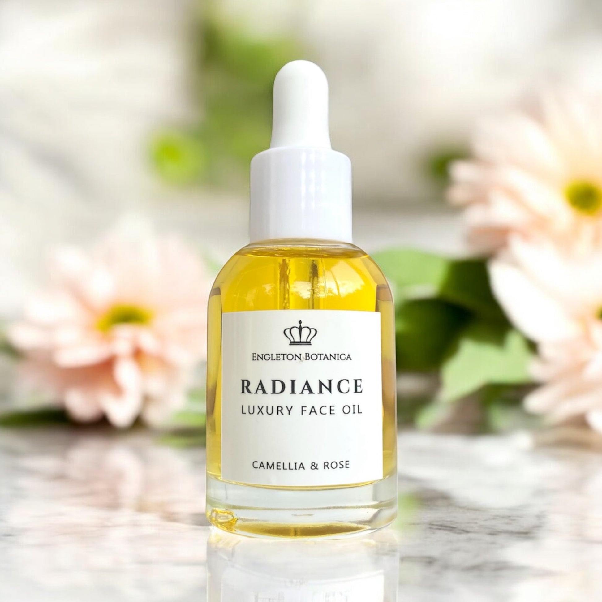 Bottle of Radiance Luxury Face Oil from Engleton Botanica with a blurred floral background