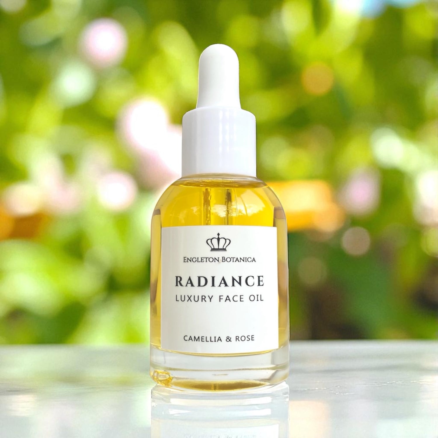 Bottle of Radiance Luxury Face Oil with a blurred green background